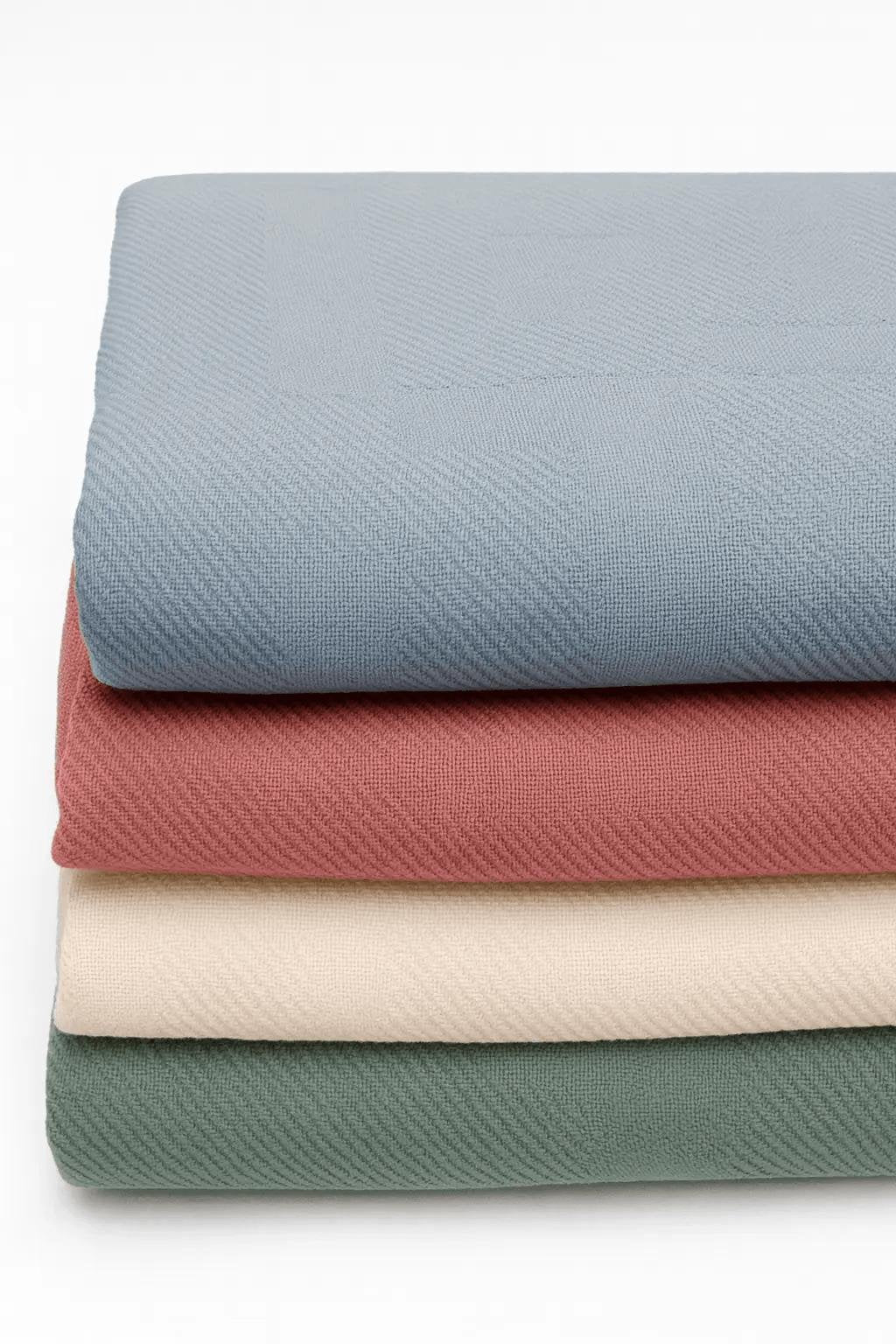 Stack of folded institutional blankets for behavioral health and rehab facilities