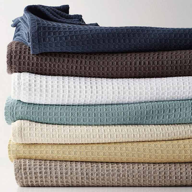 Stacked bulk blankets folded in warehouse setting