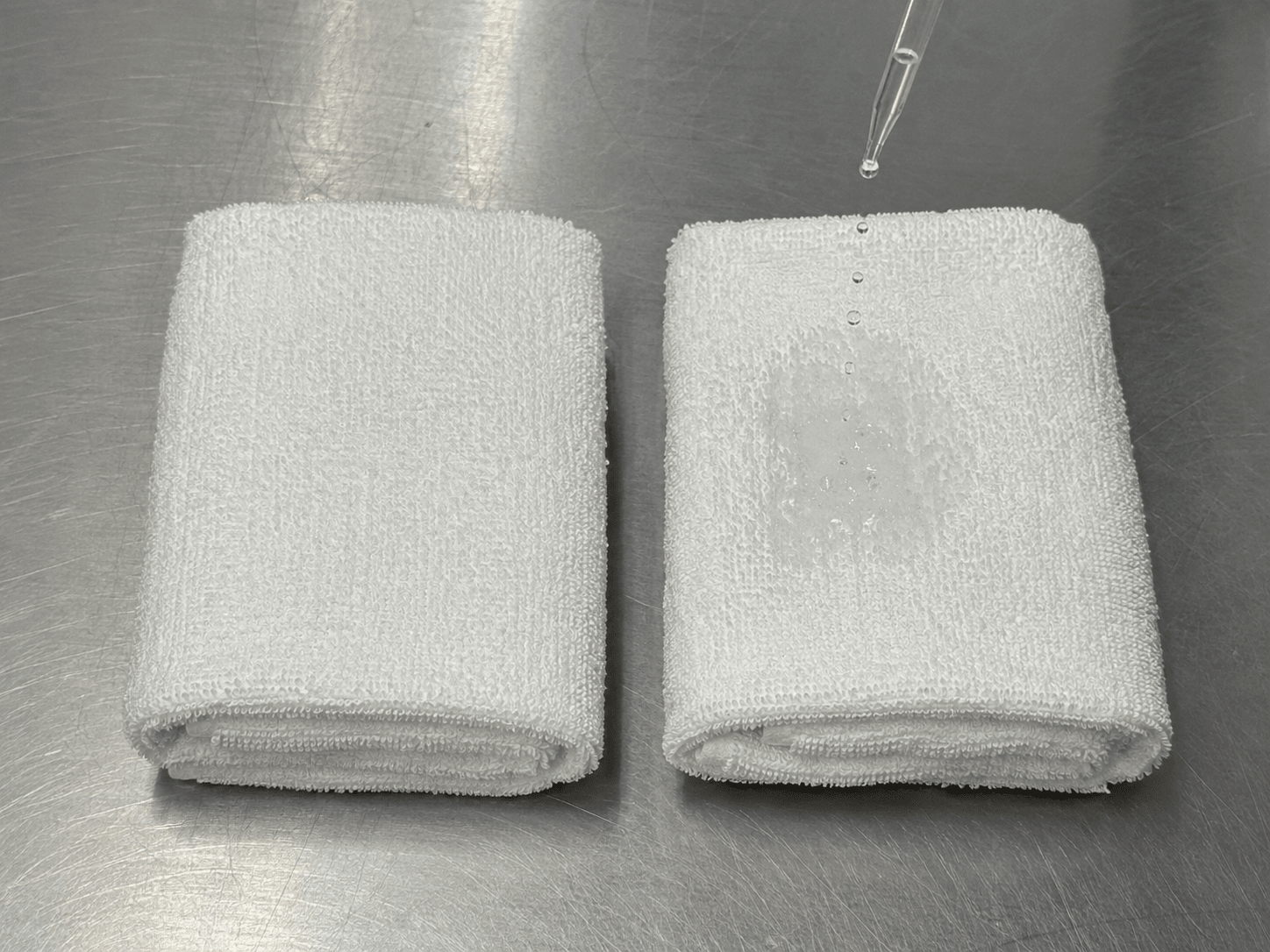Water droplet beading on a white towel instead of absorbing