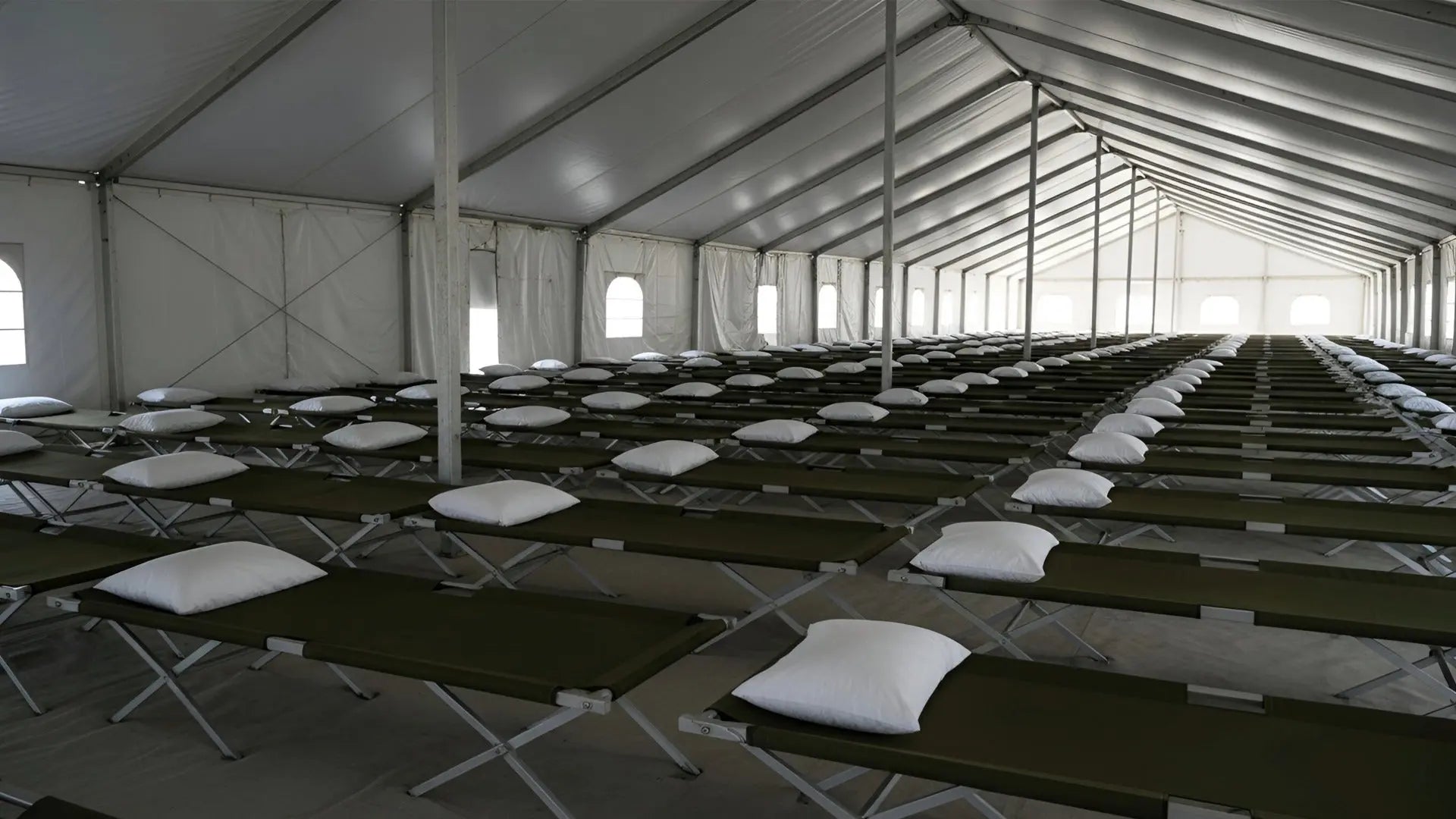 Emergency shelter sleeping pillows stacked in facility