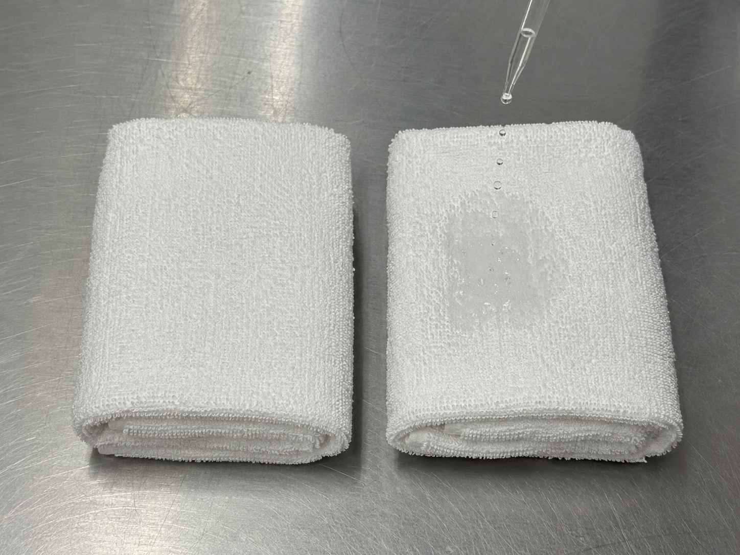 Water droplet beading on a white towel instead of absorbing