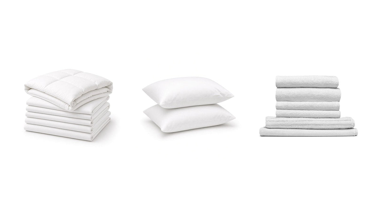 Folded white sheets, white sleeping pillows and stacked towels on a clean white background, ready for a government order