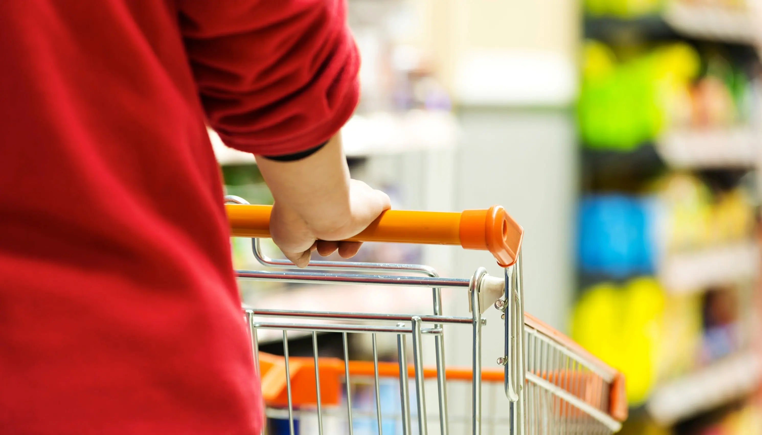 Person shopping for retail pillows with shopping cart