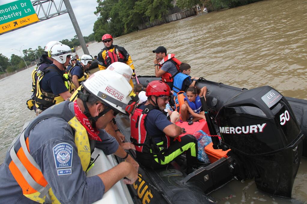 FEMA National Urban Search & Rescue team conducting flood rescue operations, representing government disaster relief efforts and the need for immediate emergency textile supplies.